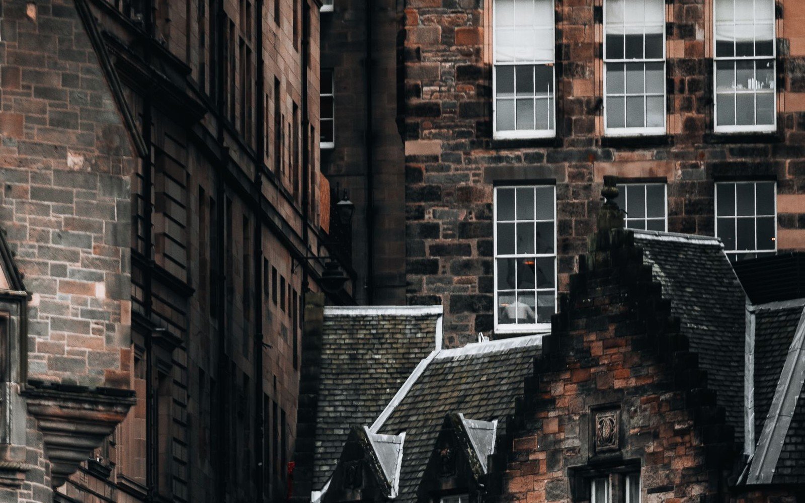 Traditional stone tenement facades with sash windows and slate roofs in Edinburgh