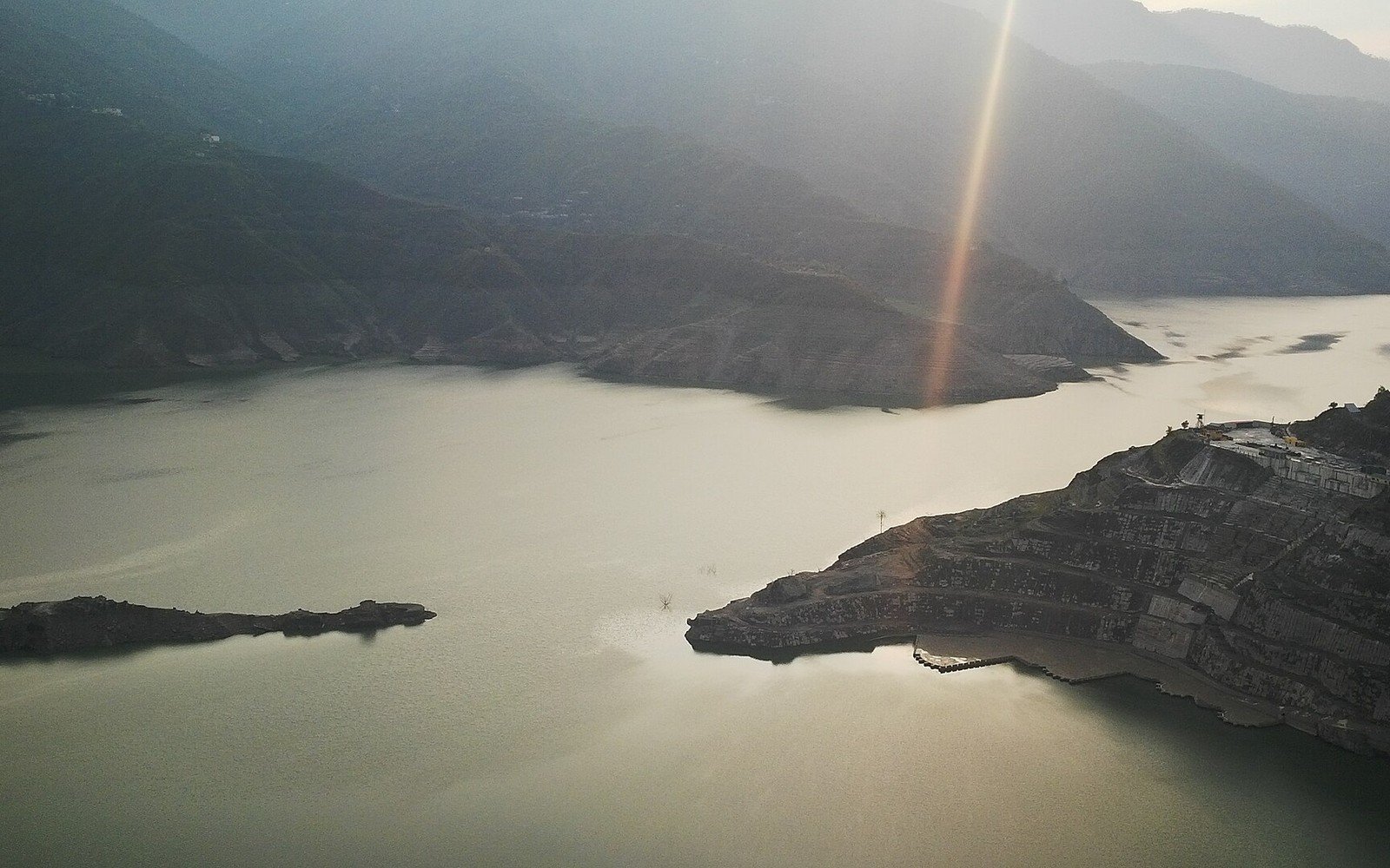 The reservoir behind the Tehri dam among steep hills at sunrise