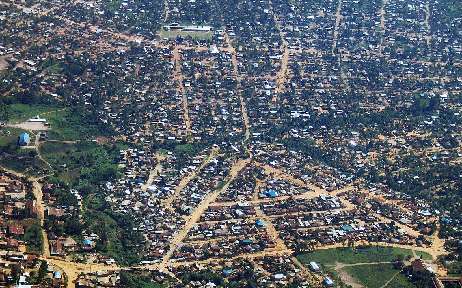 Metal roofs and unpaved streets of Bunia seen from the air