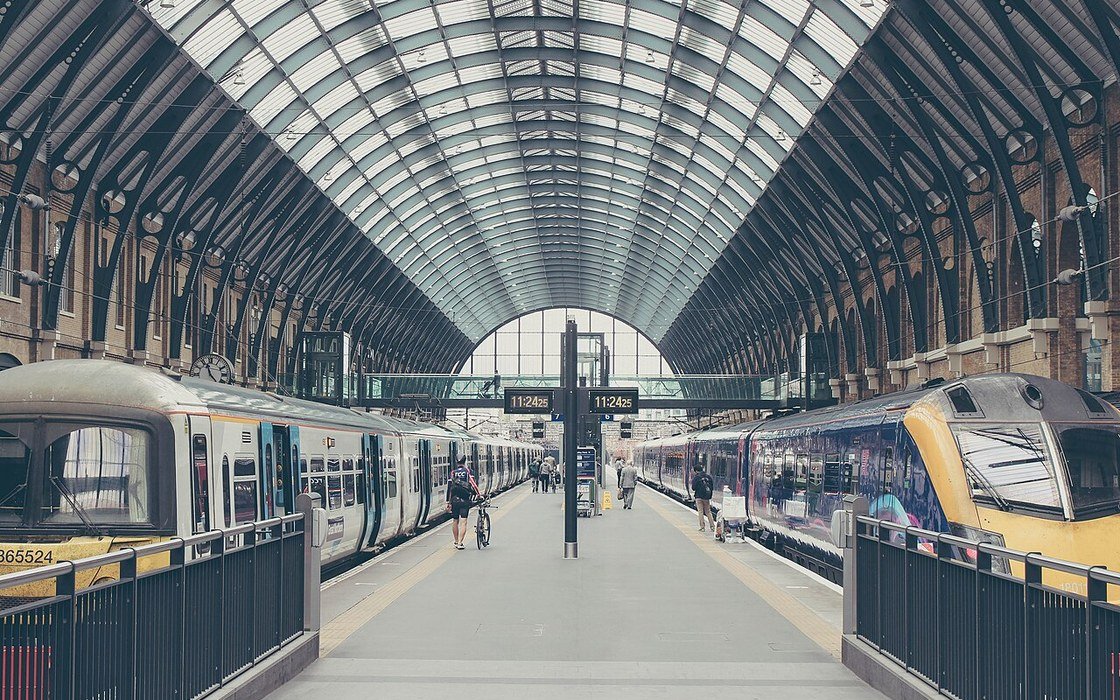 Trains at the platforms under the arched roof of King's Cross station in London