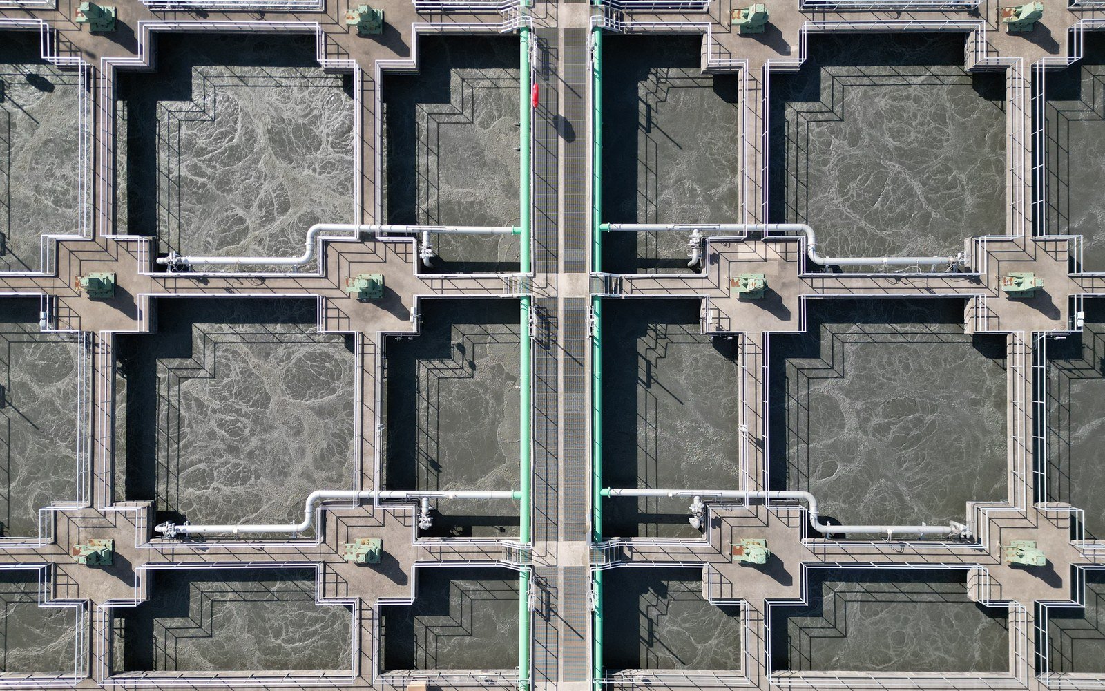 Aerial view of rectangular treatment tanks and pipework at a water treatment works