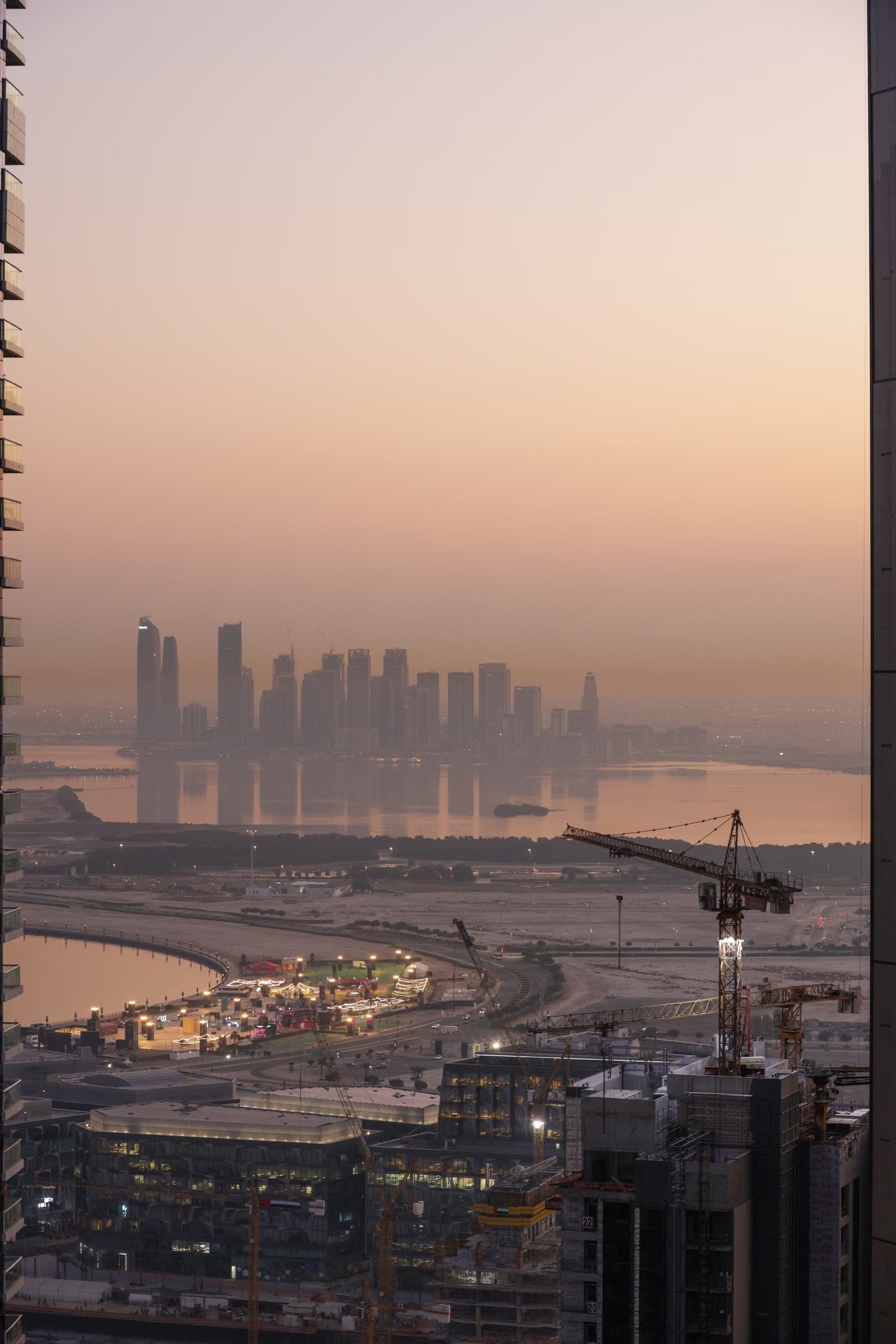 Doha skyline and construction cranes at sunset