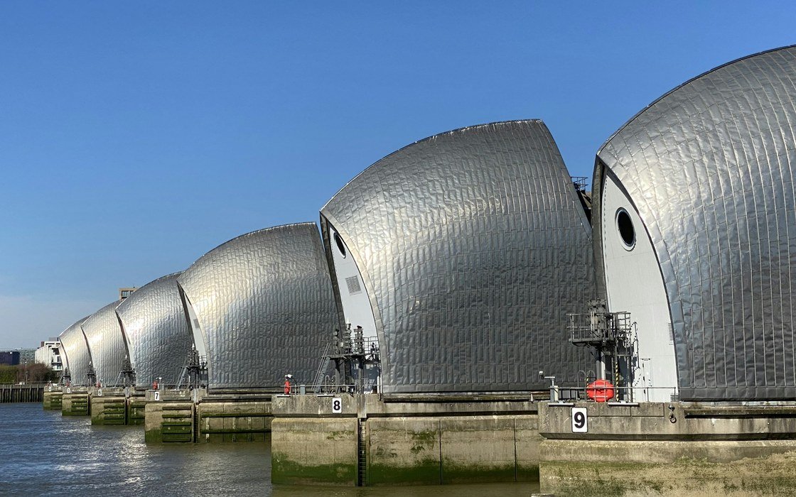 The steel shells of the Thames Barrier standing in the river at London under a clear sky