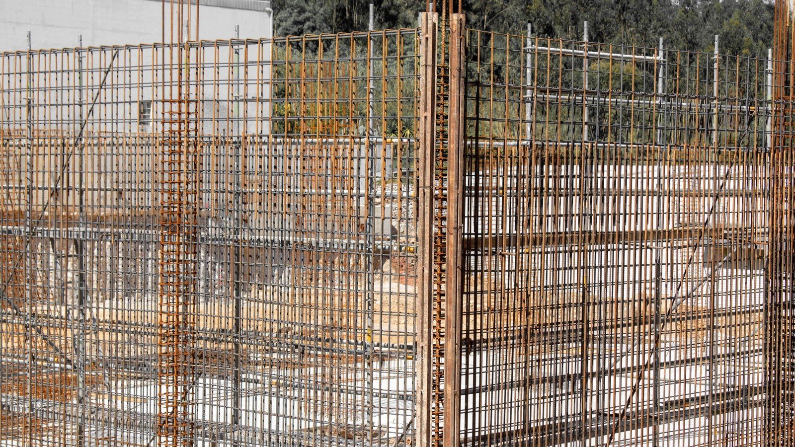 Steel reinforcement bars and formwork standing at a concrete construction site