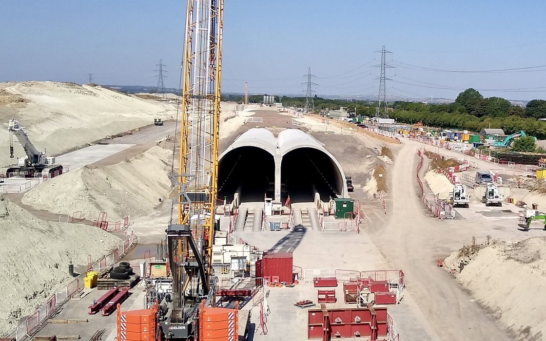 Twin tunnel portals under construction on a railway earthworks site at Wendover, with piling rigs, site fencing and spoil banks