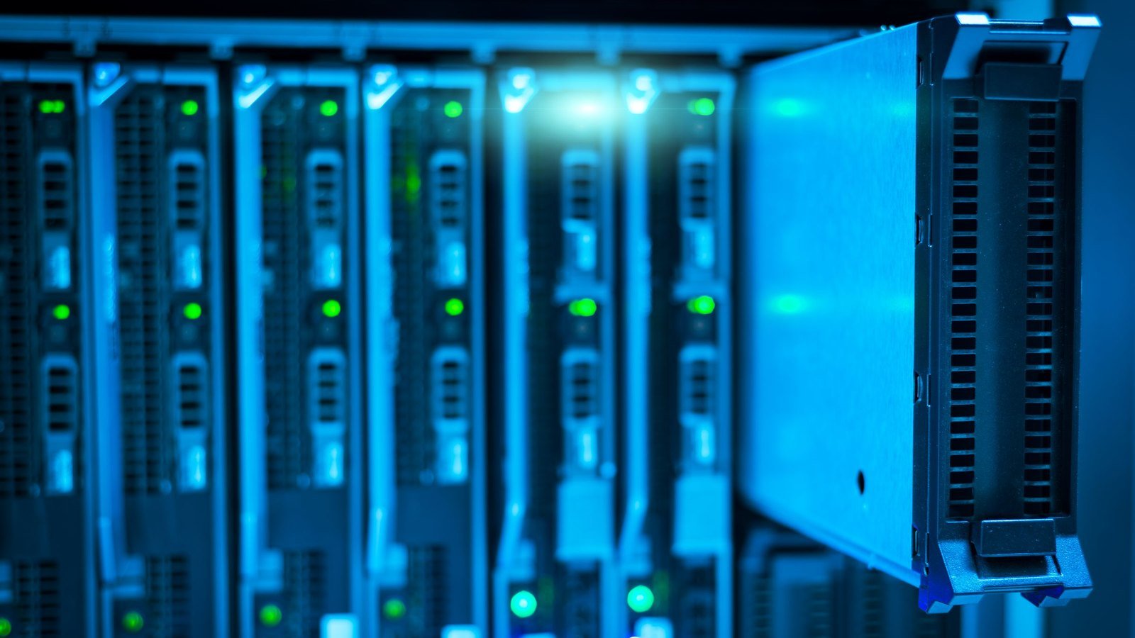 Server blades in a rack lit blue with a single unit pulled part way out