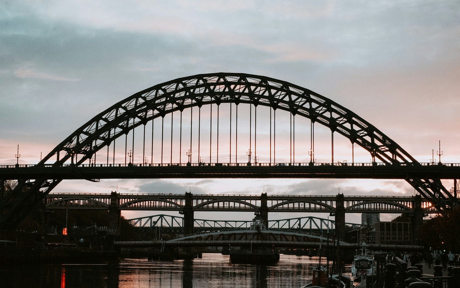 The Tyne Bridge and two further bridges over the River Tyne at dusk, seen from the Quayside