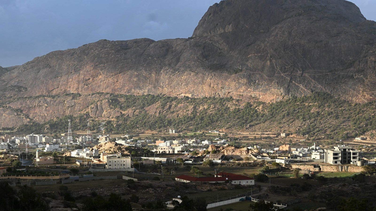 A town in the highlands of Aseer Province, Saudi Arabia, below a mountain ridge