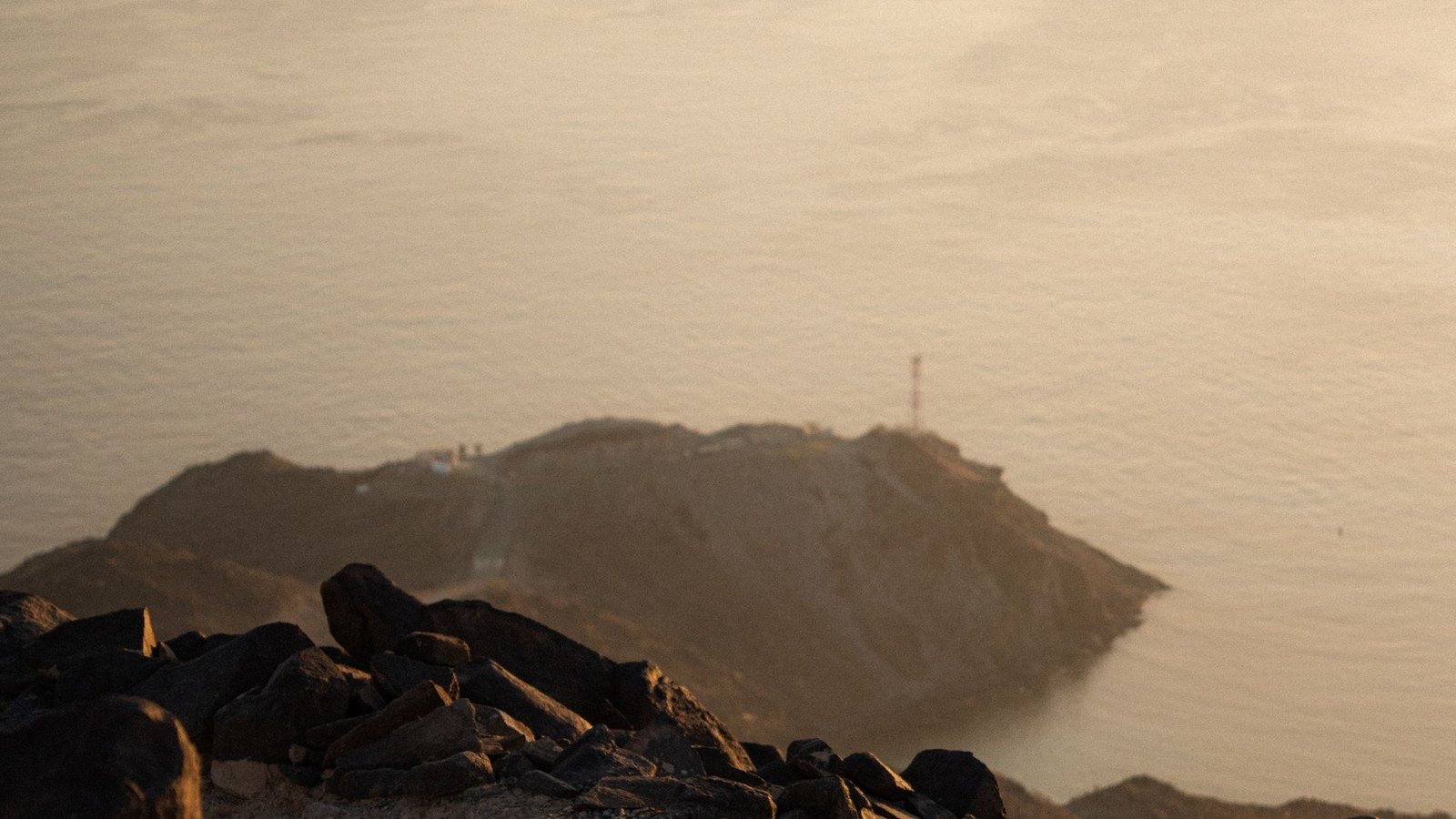 A rocky mountain headland above the sea at Khor Fakkan on the east coast of the United Arab Emirates