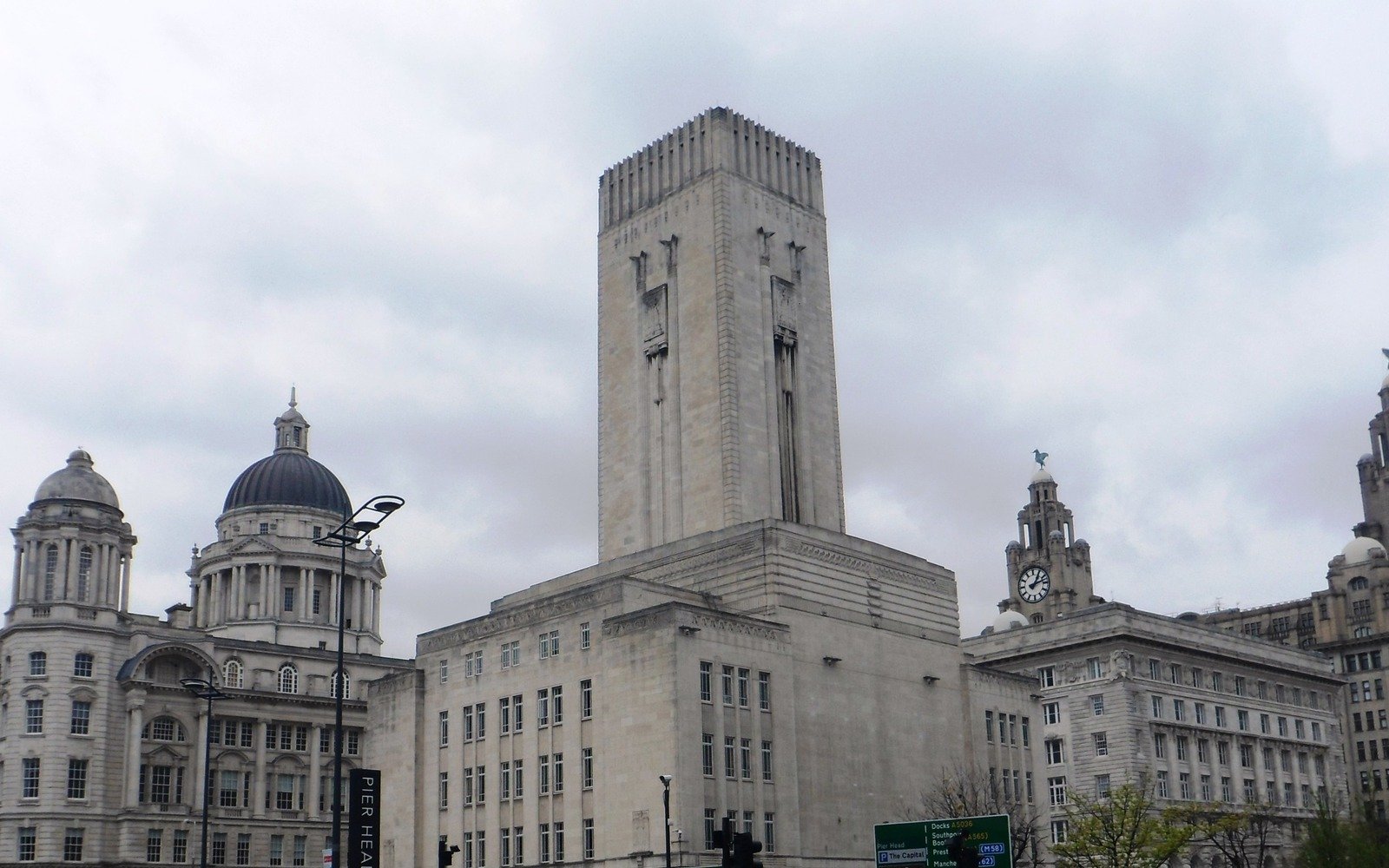 Stone civic and commercial buildings at Pier Head in Liverpool beneath a grey sky