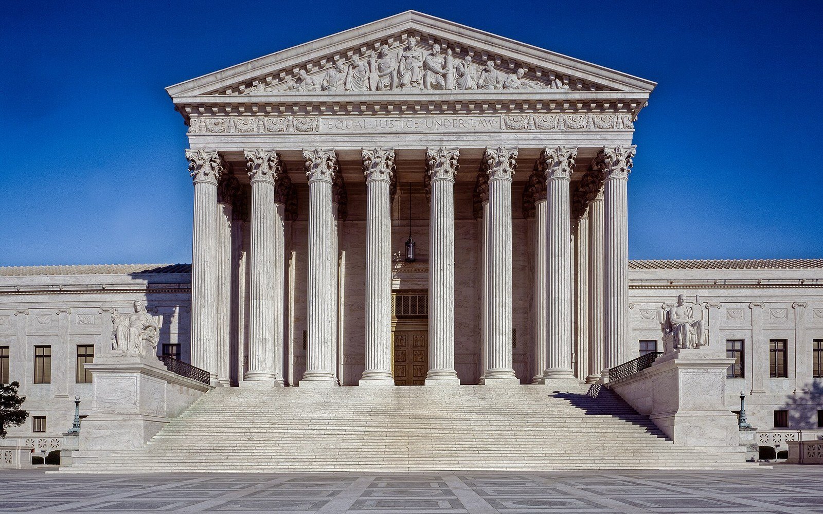 The west front of the United States Supreme Court building against a clear sky