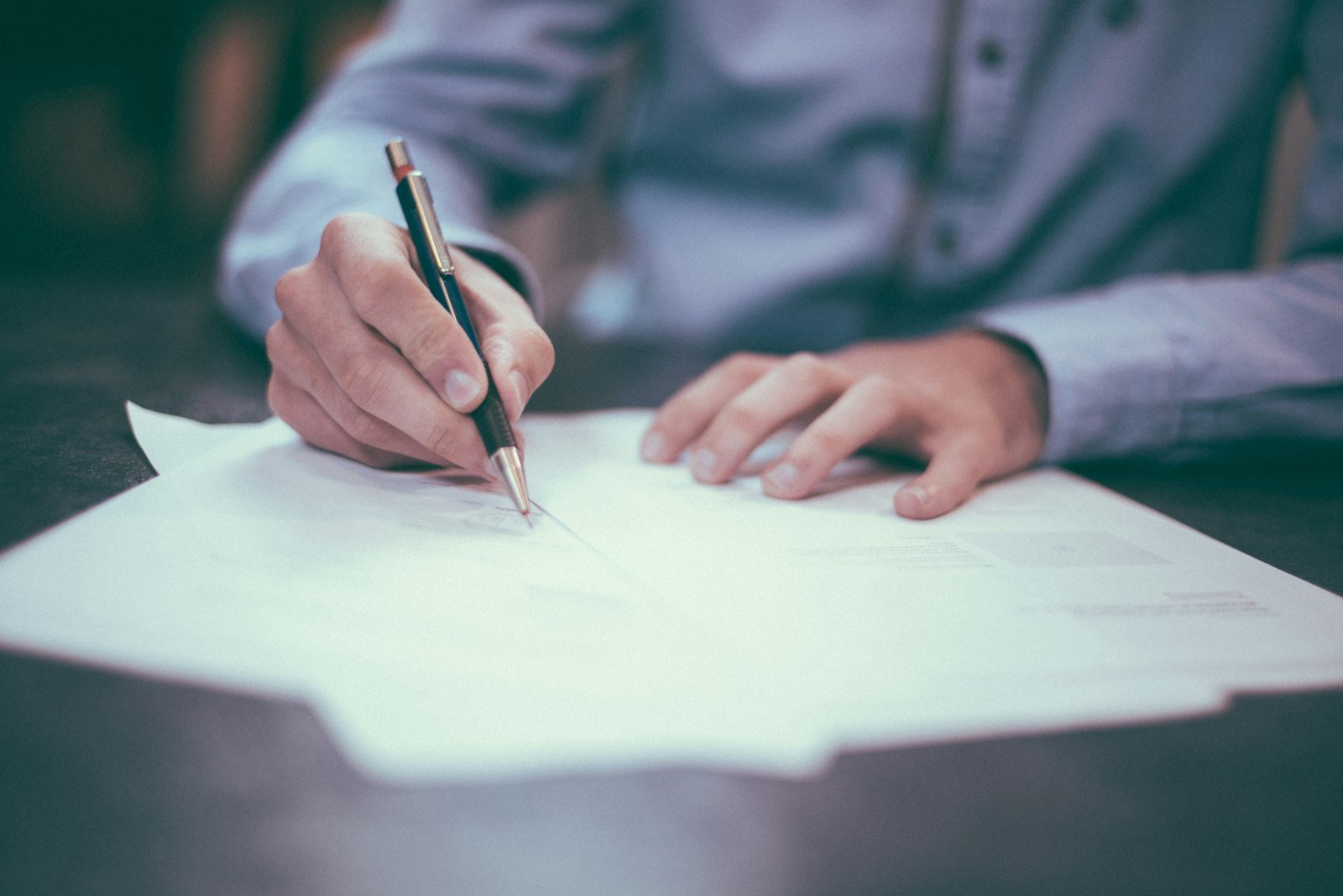 Offer papers and pen on desk