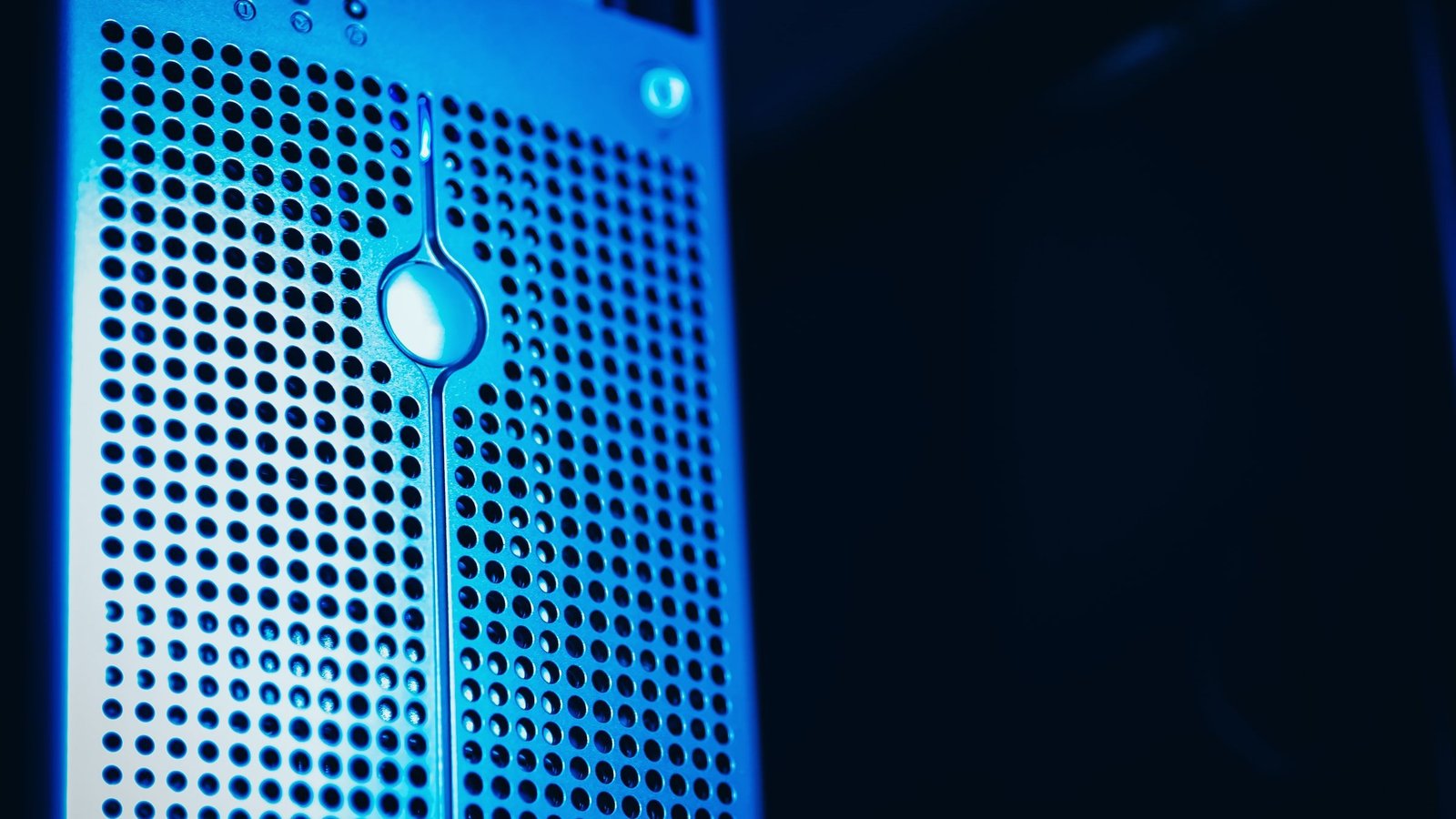 A close view of blue-lit server hardware with a perforated metal panel and no visible branding