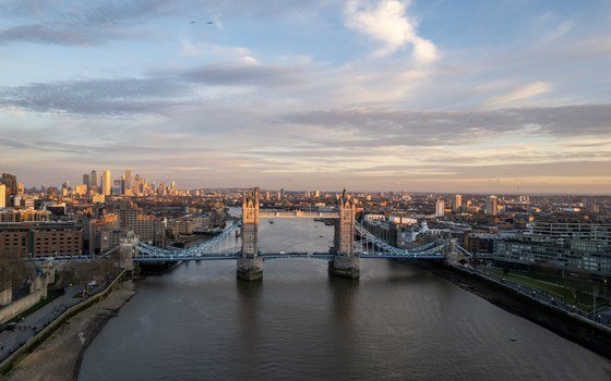A river crossing and the wider city of London seen from the air at dusk