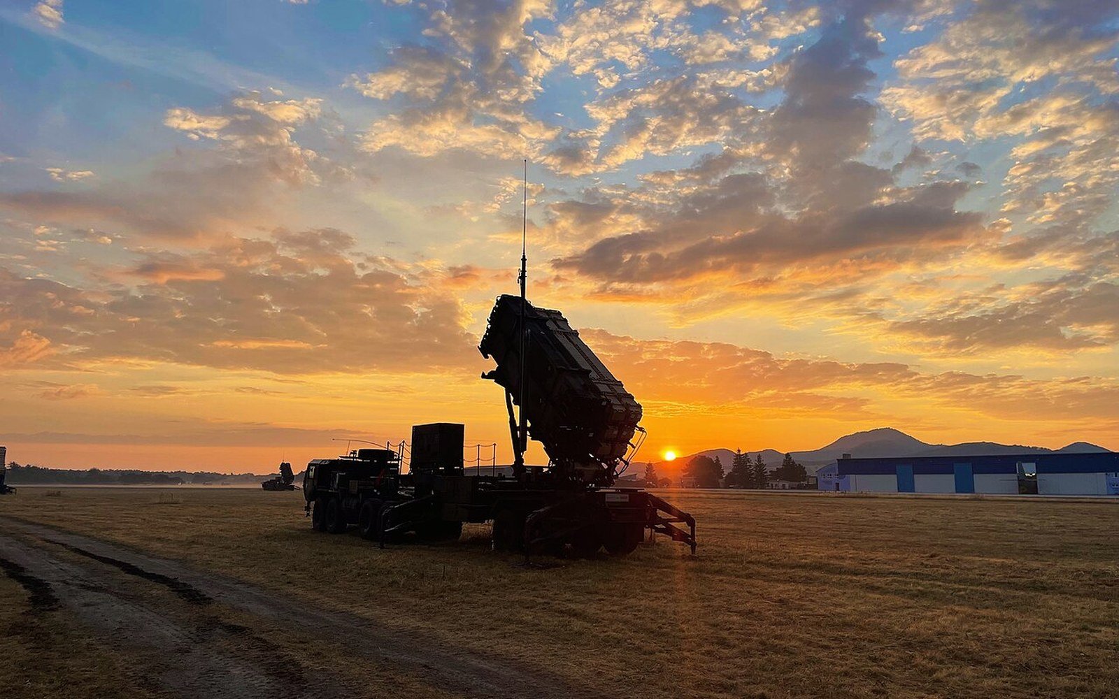 A Patriot launcher raised on a field at sunrise in Slovakia