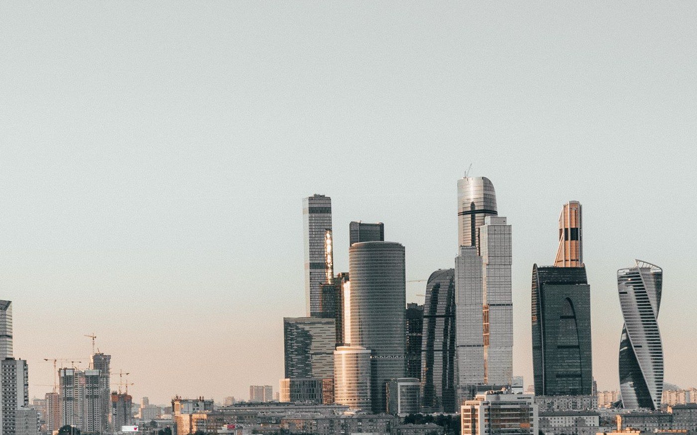 The skyscraper cluster of Moscow's business district at dusk, seen across the lower city