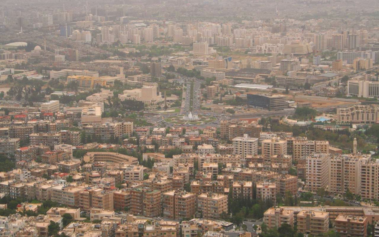 Low sun over the rooftops and apartment blocks of Damascus seen from high ground