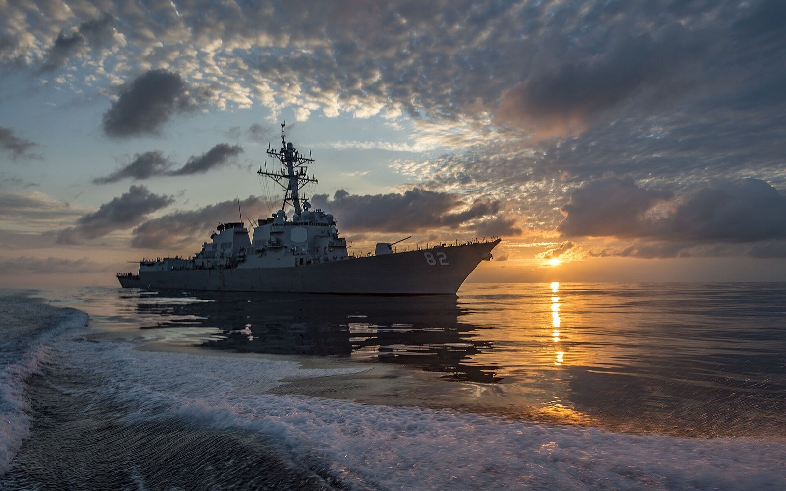 A United States Navy destroyer under way at sunset on the eastern Pacific