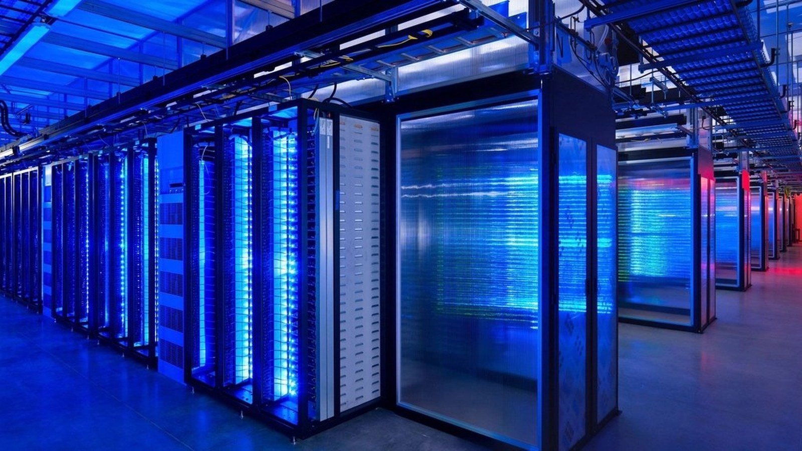 A long aisle of server cabinets inside a data hall