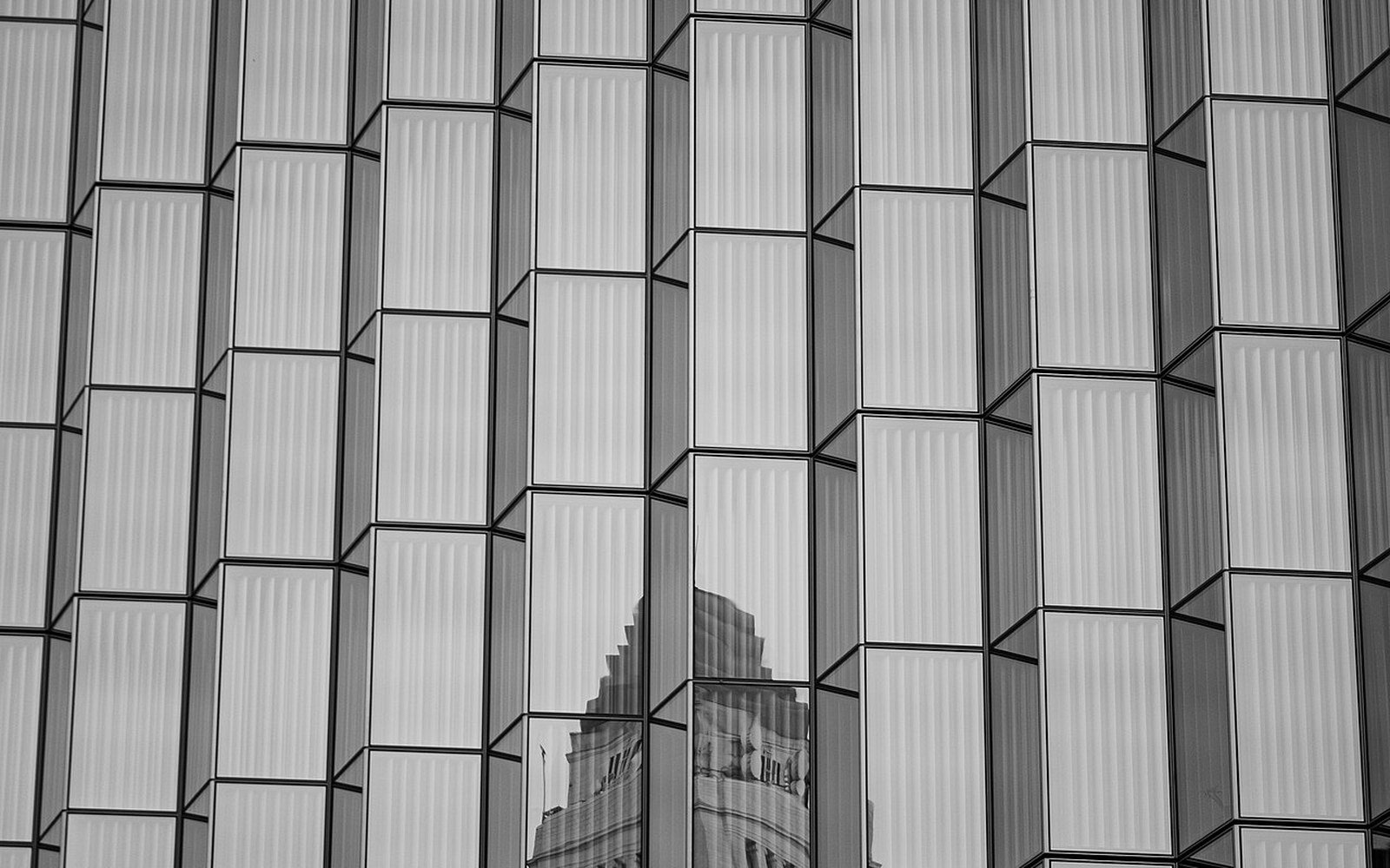 The tower of Los Angeles City Hall reflected in the glazed facade of a neighbouring building in downtown Los Angeles