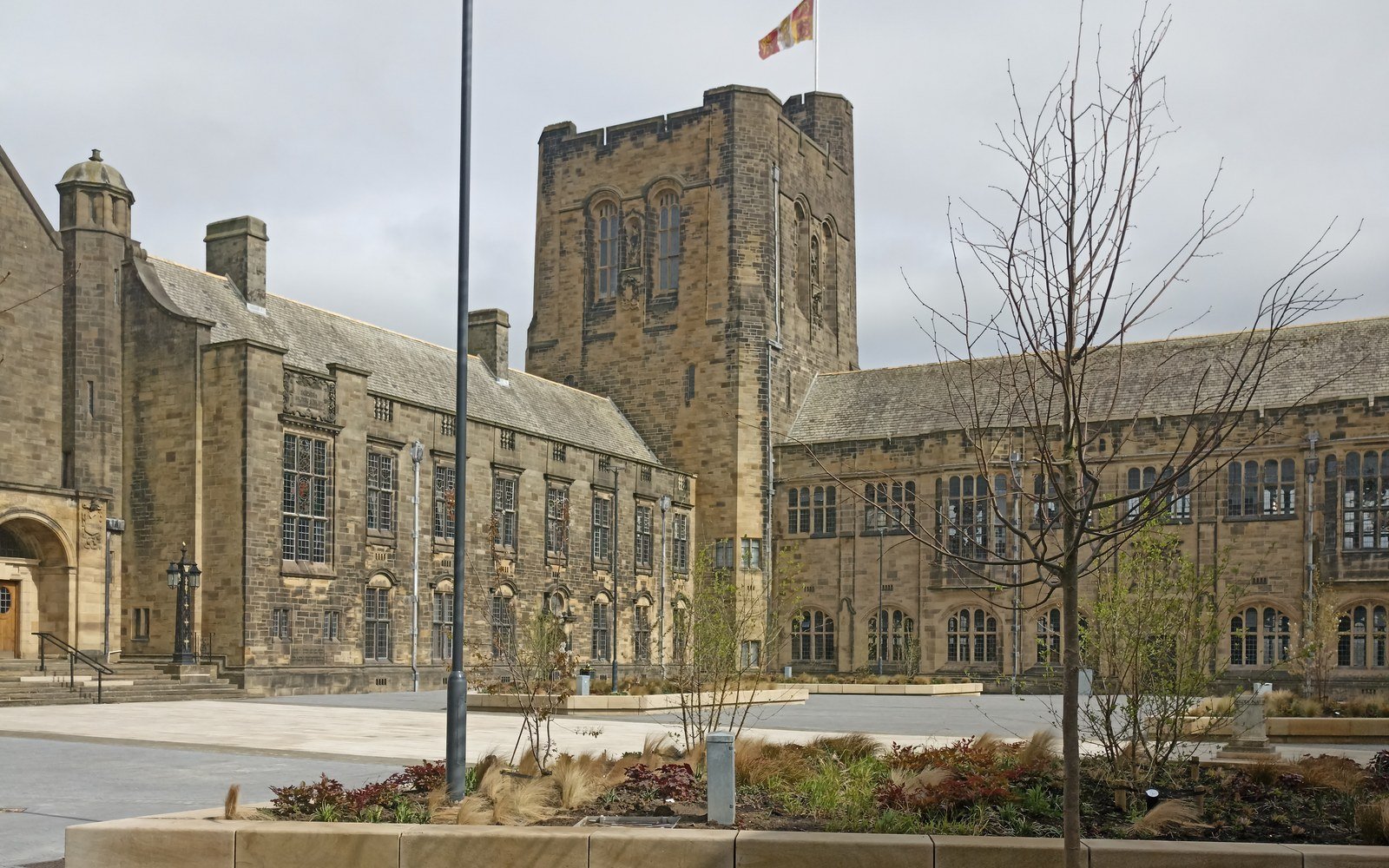 The stone quadrangle and tower of the main building at Bangor University, seen from the courtyard on an overcast day
