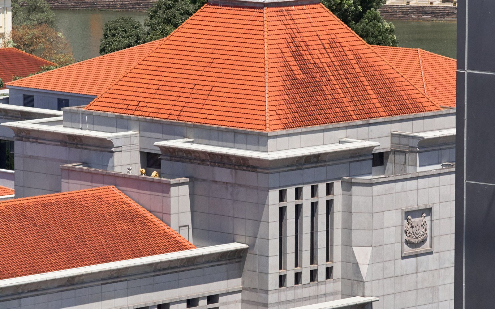 The tiled roof and crest of Parliament House in Singapore from above